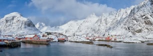 Panorama of traditional fishing village A on Lofoten Islands, Norway with red rorbu houses. With snow in winter