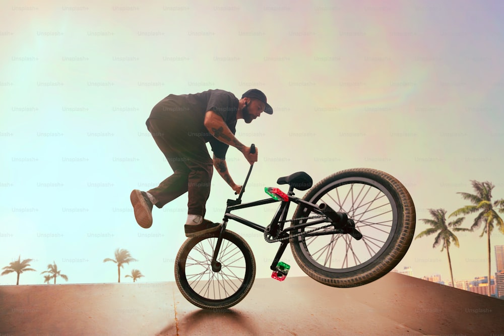 BMX rider is performing tricks in skatepark on sunset.