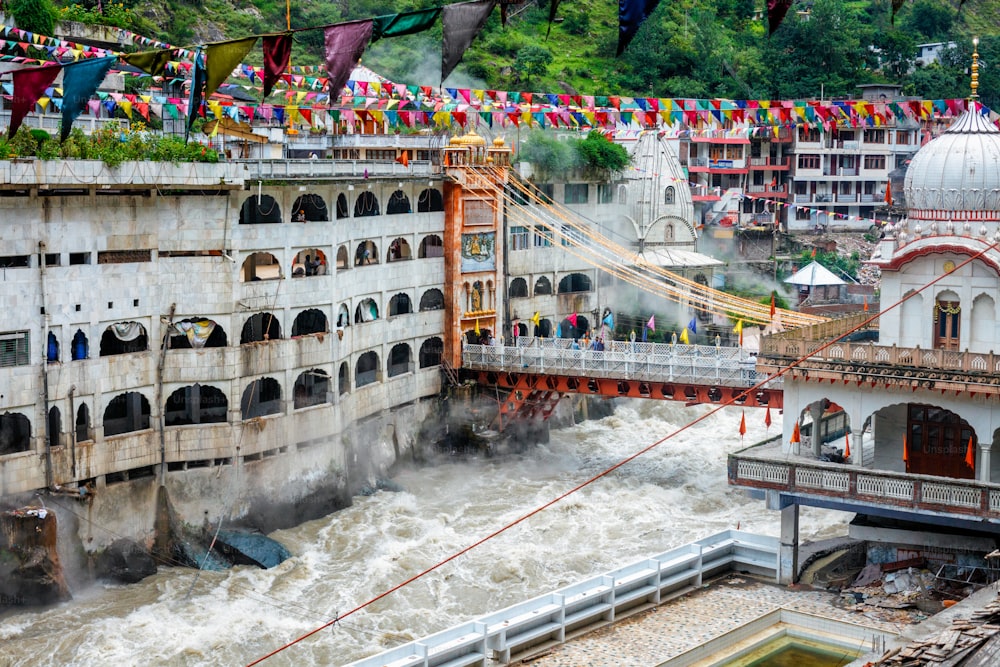 Sikh Gurdwara, bridge over Parvati river and hot springs in Manikaran Sikh sacred site in Himalayas. Himachal Pradesh, India