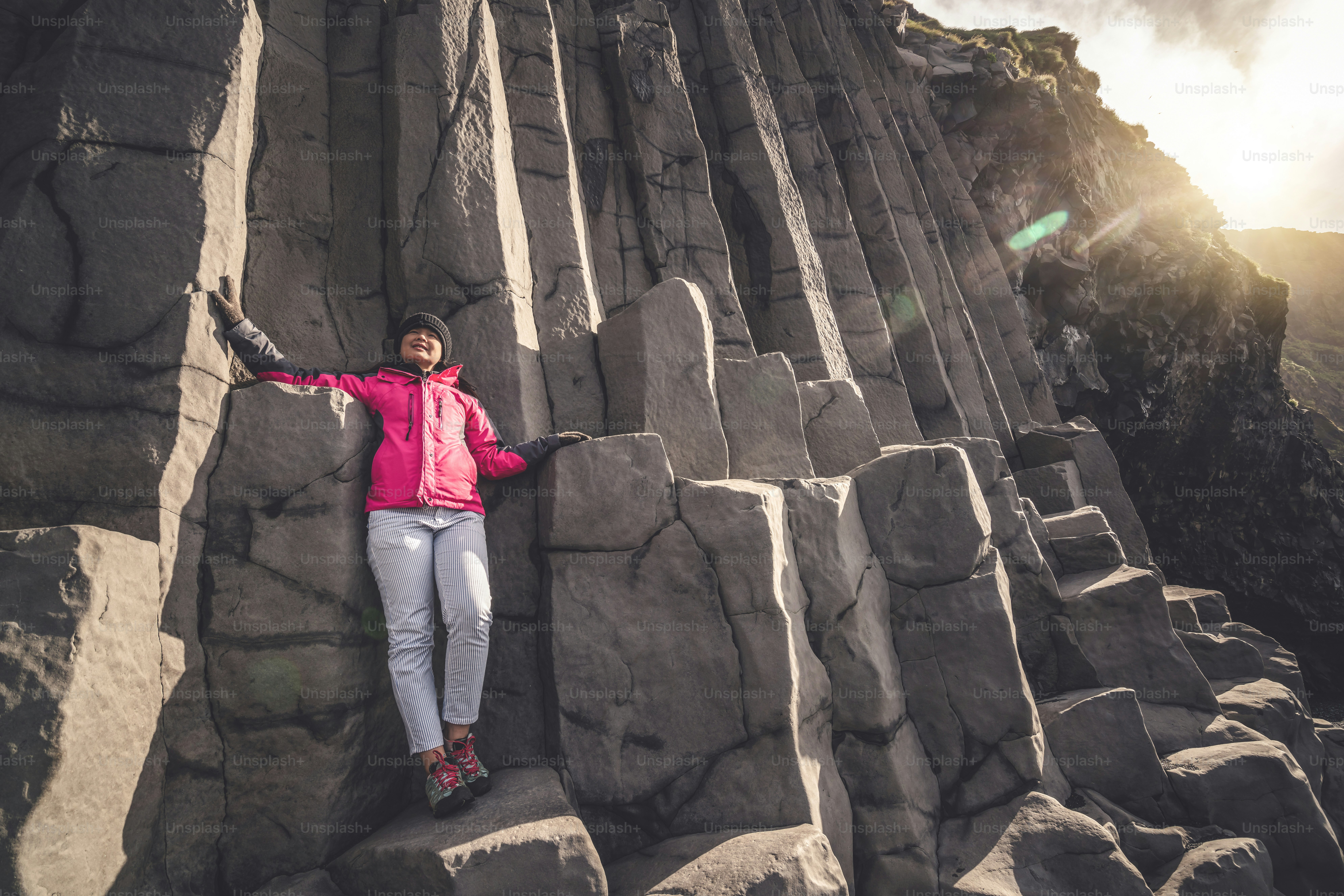 Traveler travel to unique volcanic rock formation on Iceland black sand ...
