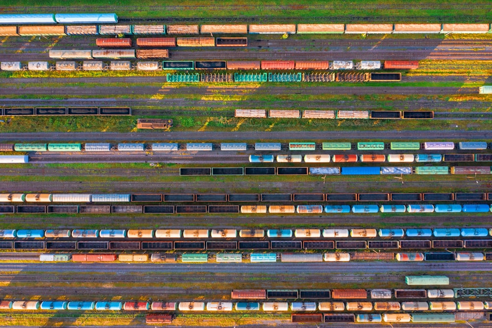 Aerial view of rail sorting freight station with railway cars, with many rail tracks railroad. Heavy industry landscape on evening sunset light