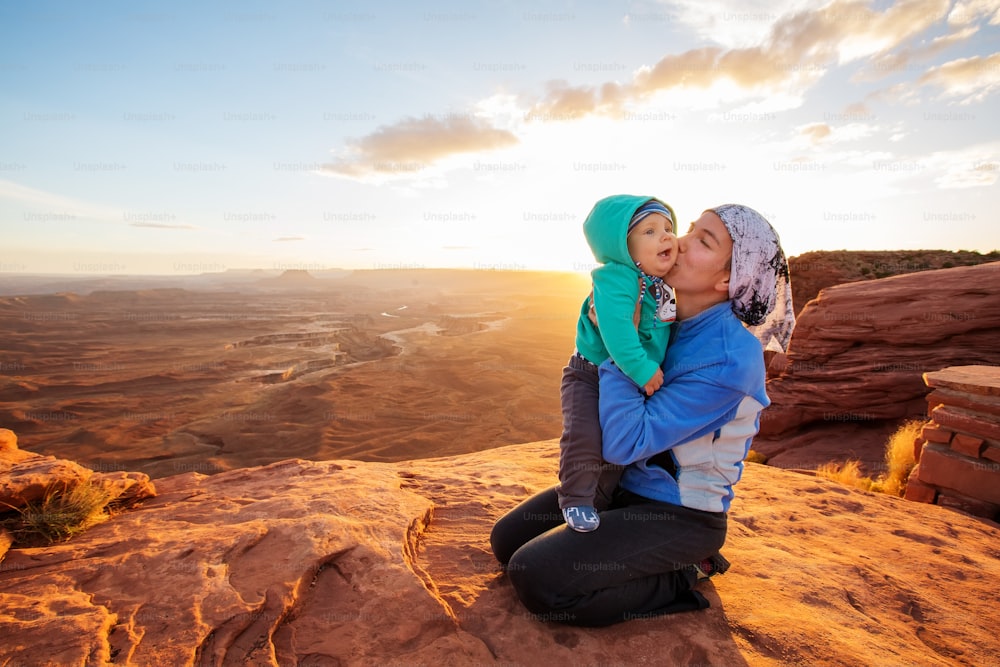 A mother and her baby son visit Canyonlands National park in Utah, USA