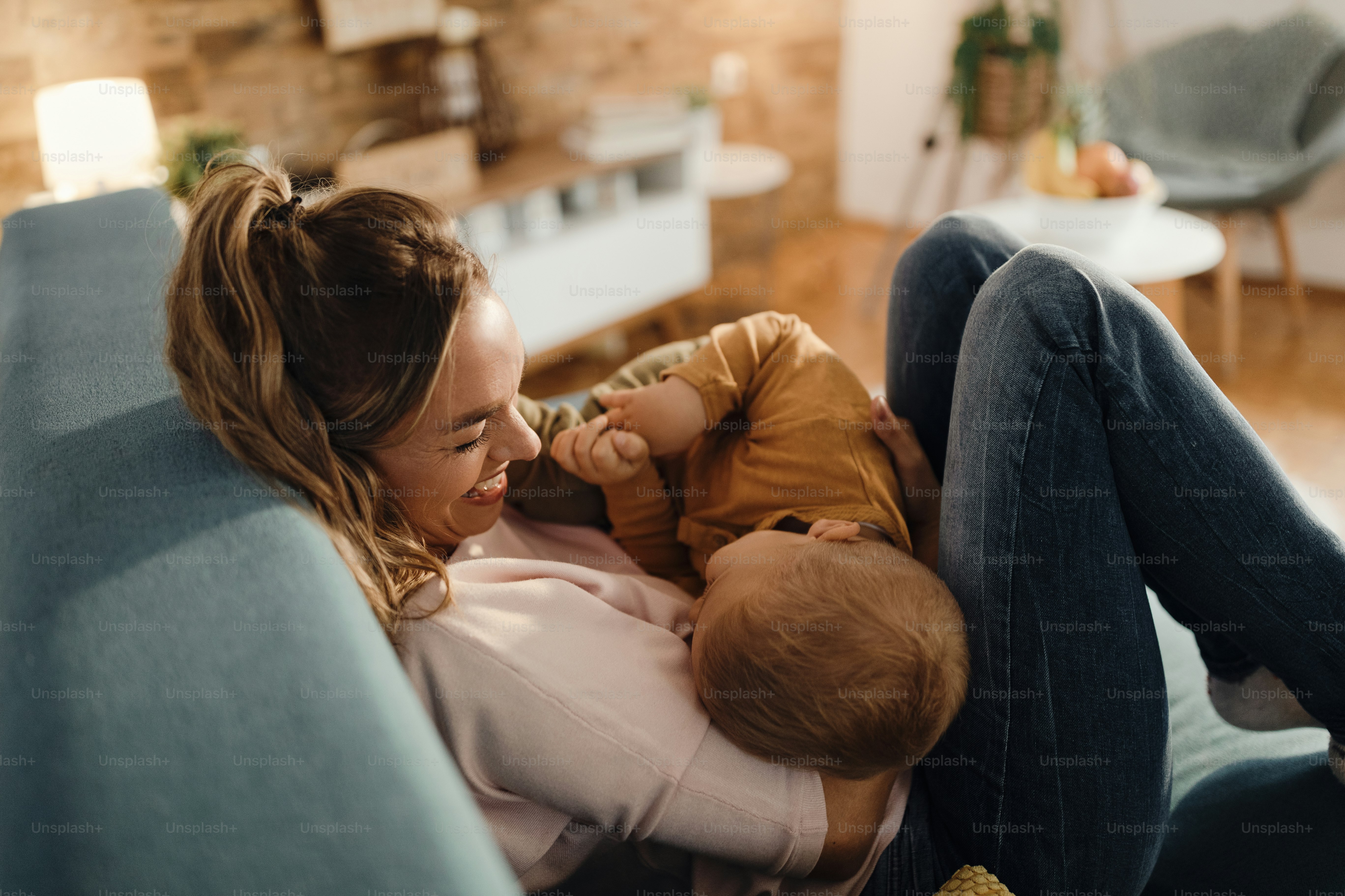 Happy mother and son having fun on the sofa at home.