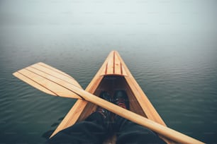 Canoe bow on the foggy lake, first person view.