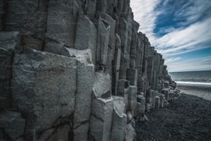 Beautiful and unique volcanic rock formation on Iceland black sand beach located near the village of Vik i myrdalin South Iceland. Hexagonal columnar rocks attract tourist who visit Iceland.