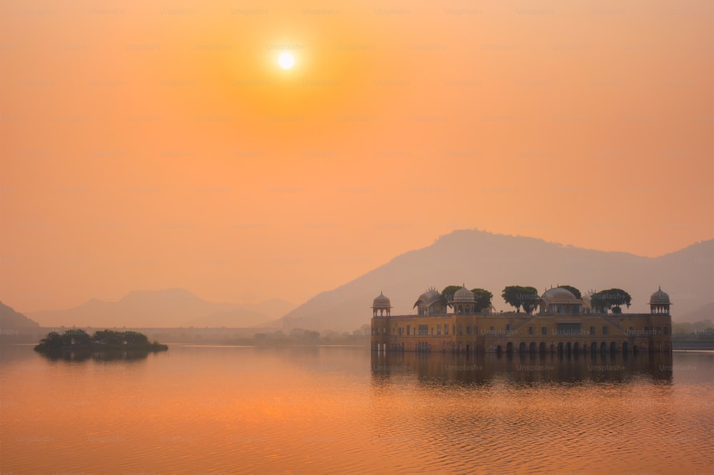 Tranquil morning at famous indian tourist landmark Jal Mahal (Water Palace) at sunrise in Jaipur. Ducks and birds around enjoy the serene morning. Jaipur, Rajasthan, India