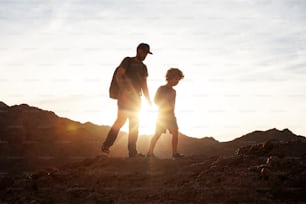 Dad with son in the mountains in the desert