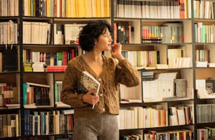 Woman with book in library.