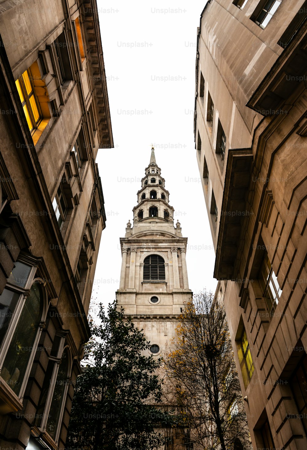 Tower of St Bride’s Church, one of the most ancient churches in London, as seen through a narrow street.