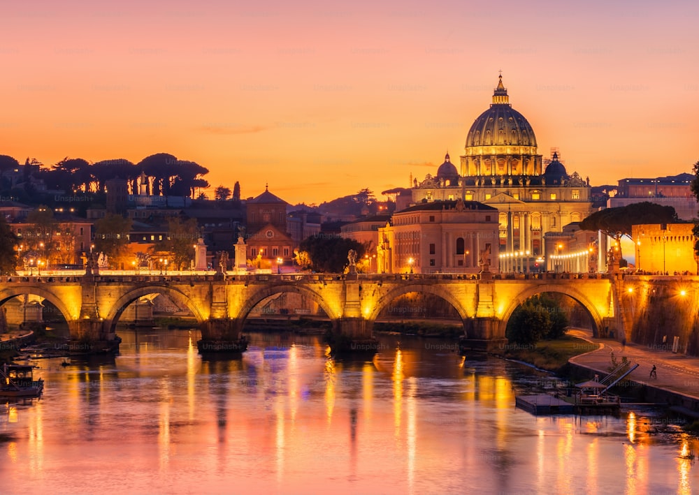 Rome Skyline with Vatican St Peter Basilica and St Angelo Bridge crossing Tiber River in city center of Rome Italy , historical landmarks attraction of the Ancient Rome , travel destination of Italy.