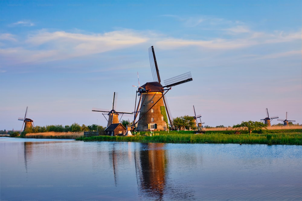 Netherlands rural lanscape with windmills at famous tourist site Kinderdijk in Holland on sunset with dramatic sky