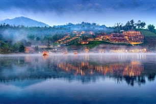 Tourists take a boat at Ban Rak Thai village in Mae Hong Son province, Thailand.