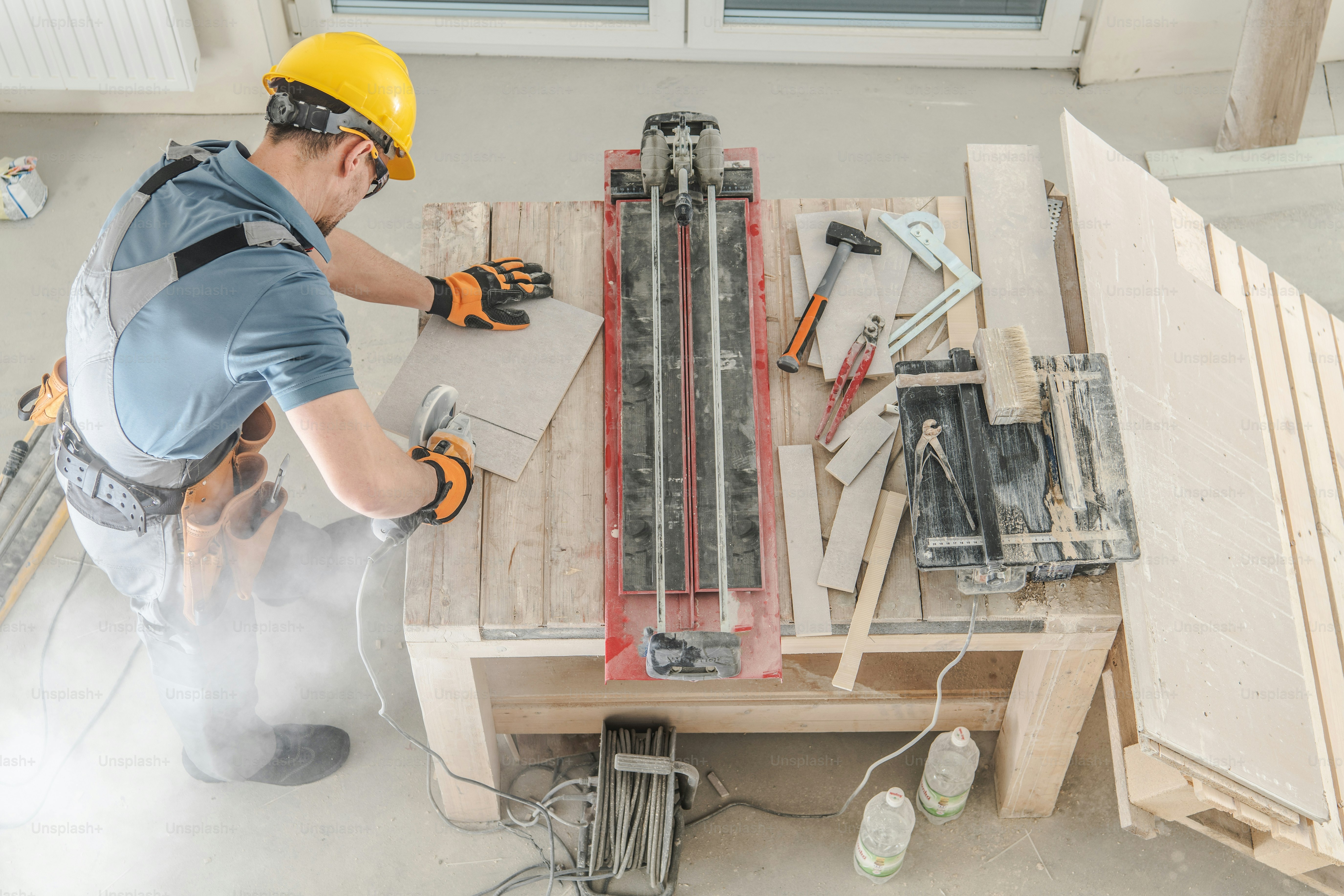 Tradesperson cutting ceramic tiles on site