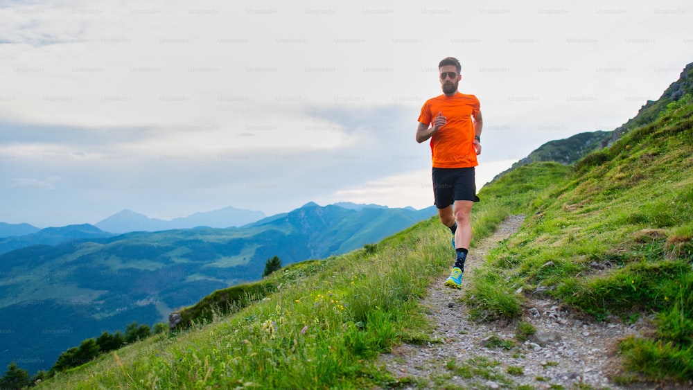 Trail running athlete during a training on mountain trail