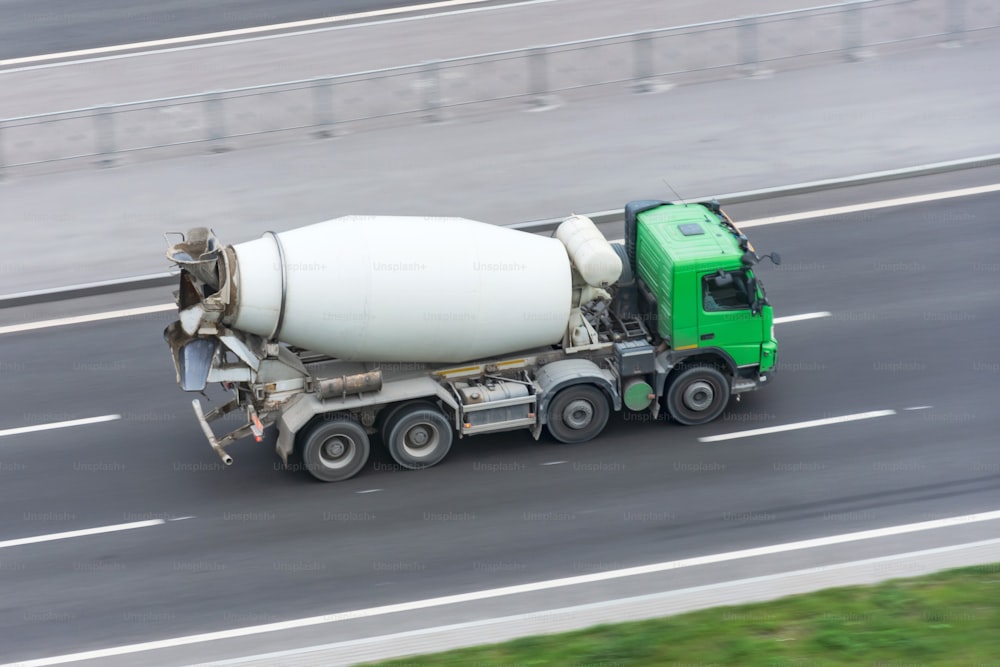 Truck with concrete mixer truck driving on the highway