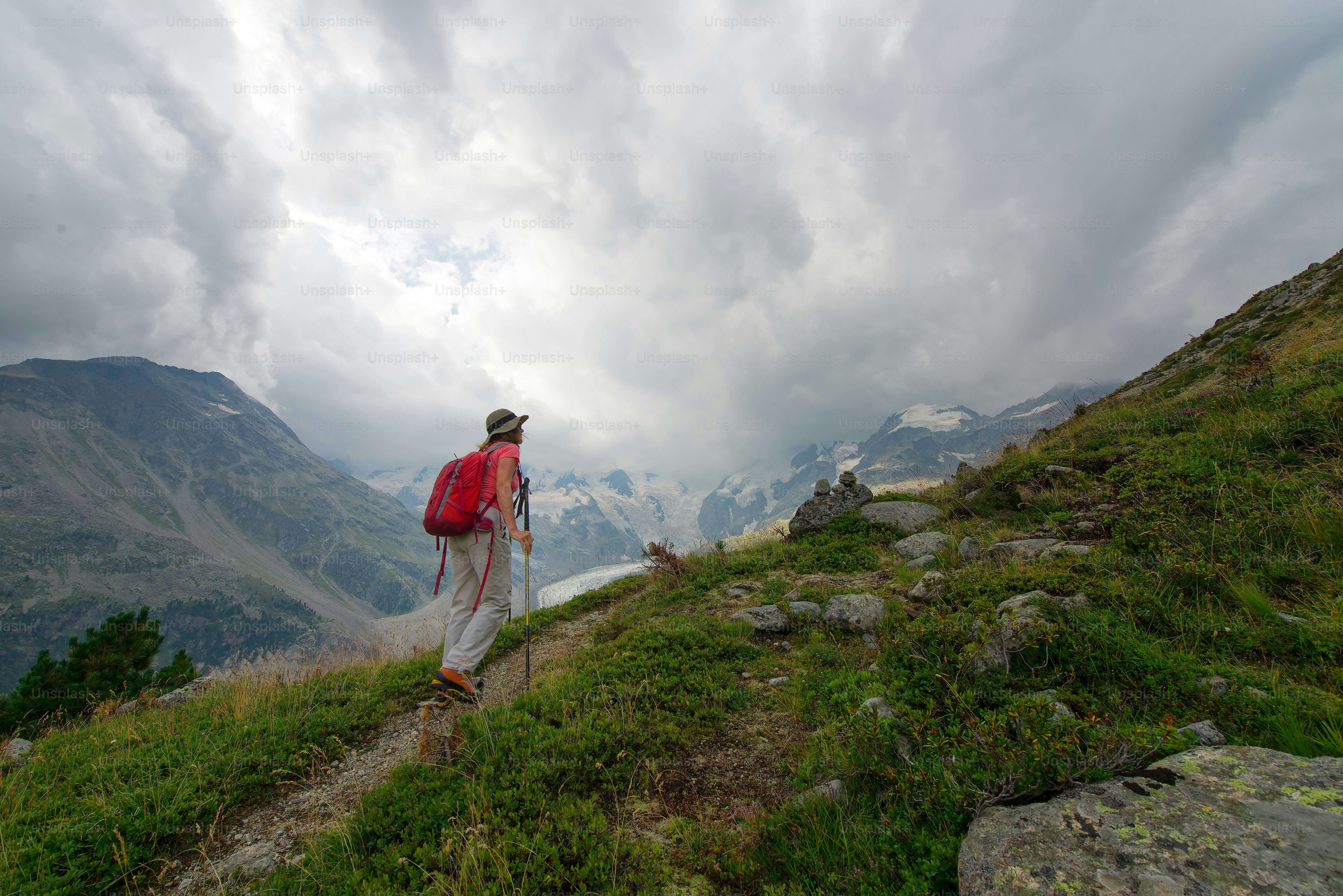 Retired woman practices a hike in the high mountains