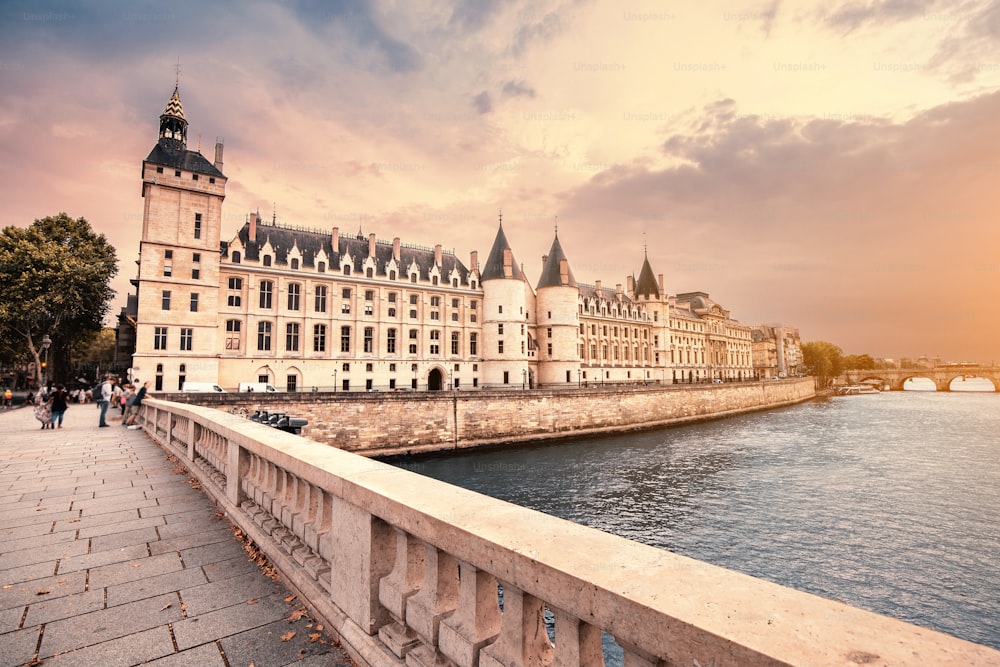 City skyline with famous building Conciergerie which used to be a prison with a bridge over the river Seine in Paris