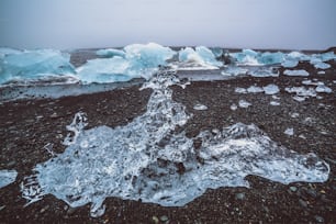 Icebergs sur Diamond Beach en Islande. La glace gelée sur la plage de sable noir connue sous le nom de Diamond Beach s’écoule de la magnifique lagune glaciaire de Jokulsarlon dans le parc national de Vatnajokull, au sud-est de l’Islande, en Europe.