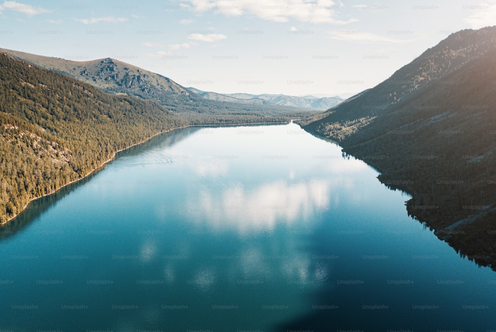 Panoramic aerial view of famous natural attraction of Altai and Russia - the Multa Lake at sunrise with majestic sky. National park and outdoor recreation background