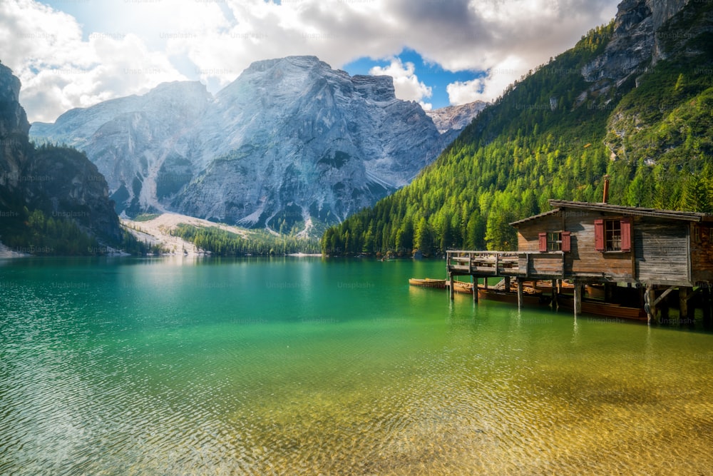 Braies Lake in Dolomites mountains Seekofel in background, Sudtirol, Italy. Lake Braies is also known as Lago di Braies. The lake is surrounded by the mountains which are reflected in the water.