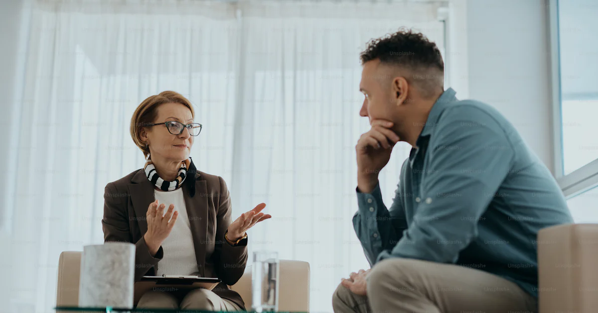 Getting Professional Help Senior mental health professional counseling a man during therapy ...