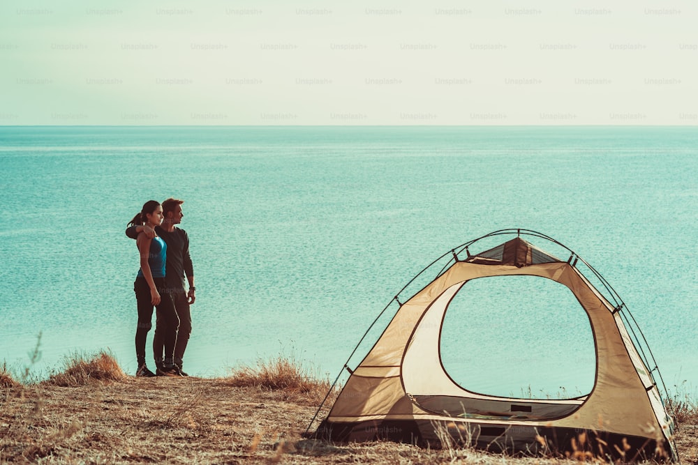 The man and woman have rest in the campsite near the sea