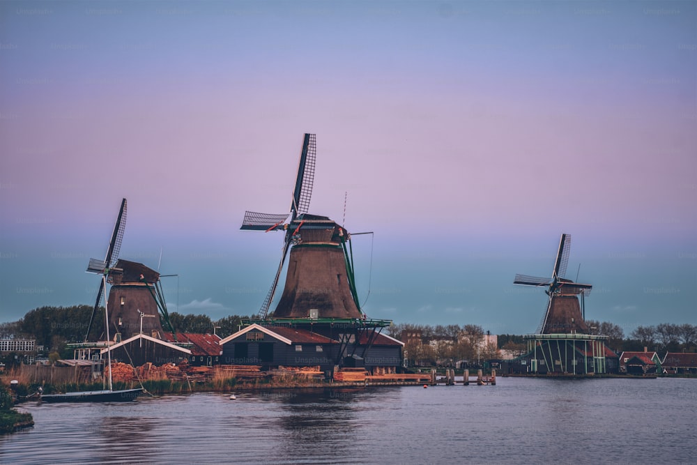 Windmills at famous tourist site Zaanse Schans in Holland in twilight after sunset. Zaandam, Netherlands