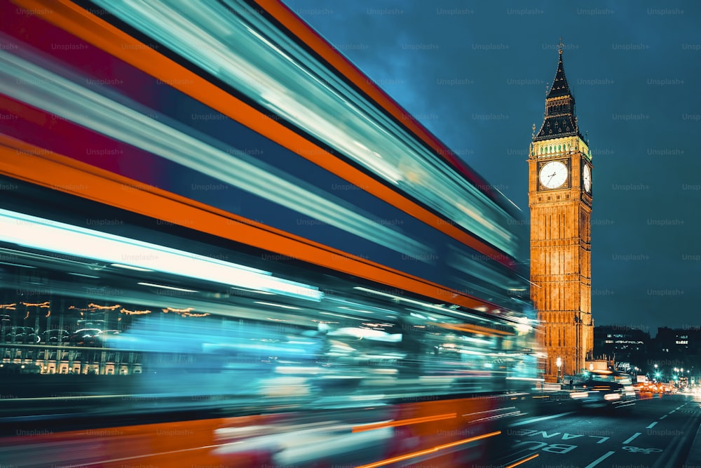 Big Ben, one of the most prominent symbols of both London and England, as shown at night along with the lights of the cars passing by