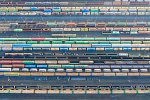 Aerial view of railroad tracks, cargo sorting station. Many different railway cars with cargo and raw materials
