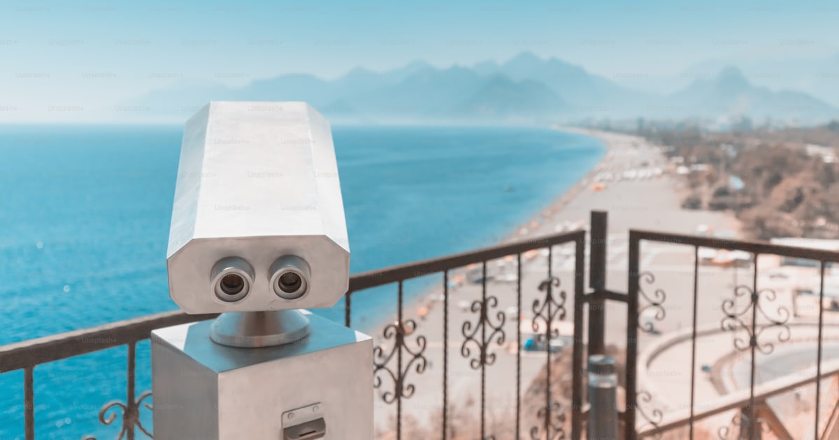 Viewpoint with a tourist telescope in a Mediterranean resort. Travel ...