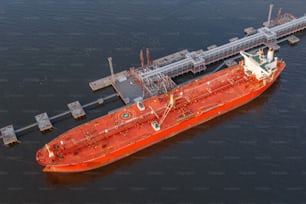 Oil tanker in industrial port at unloading of bulk contents, aerial view