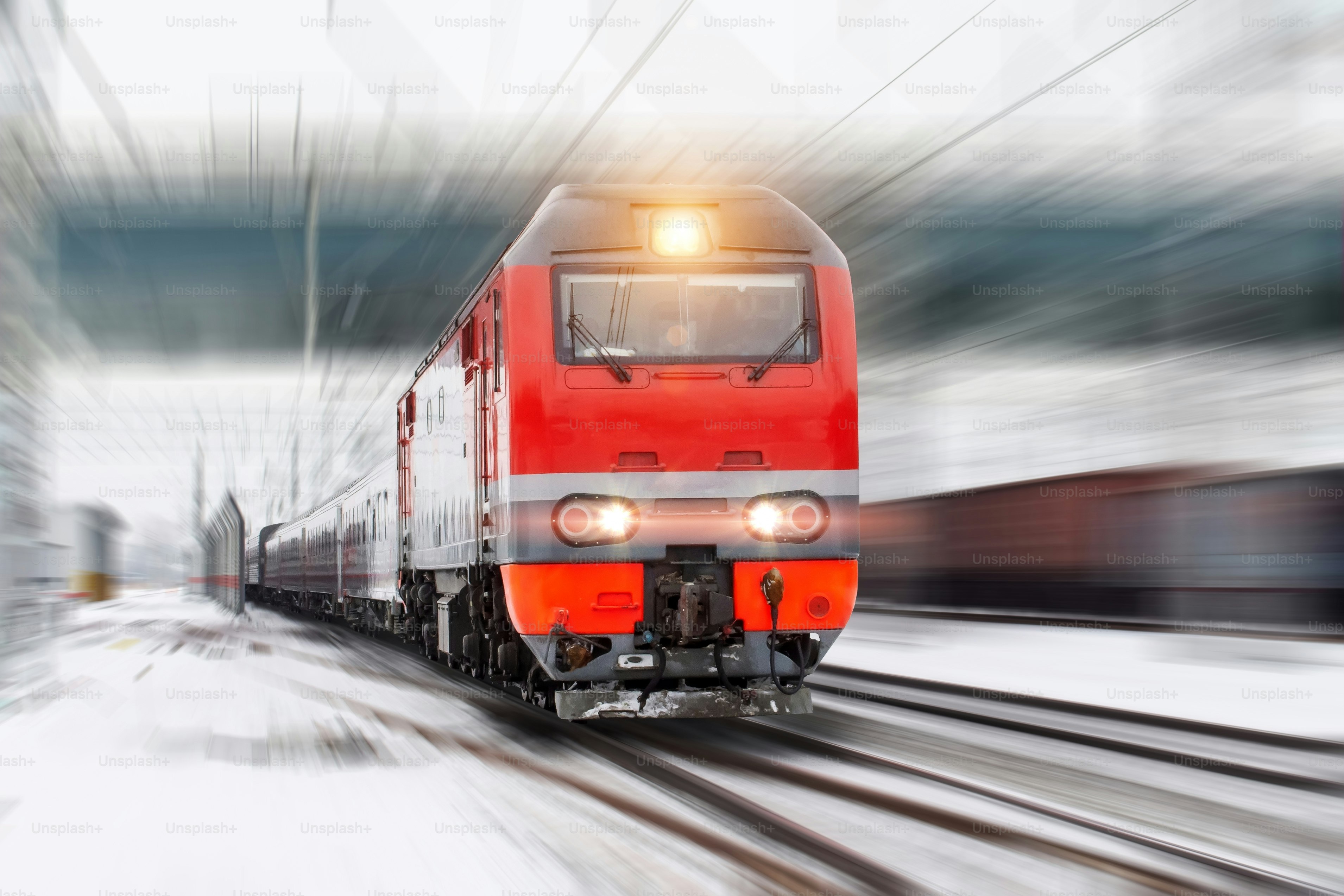 Winter landscape on a high-speed railway road, a racing locomotive with passenger wagons