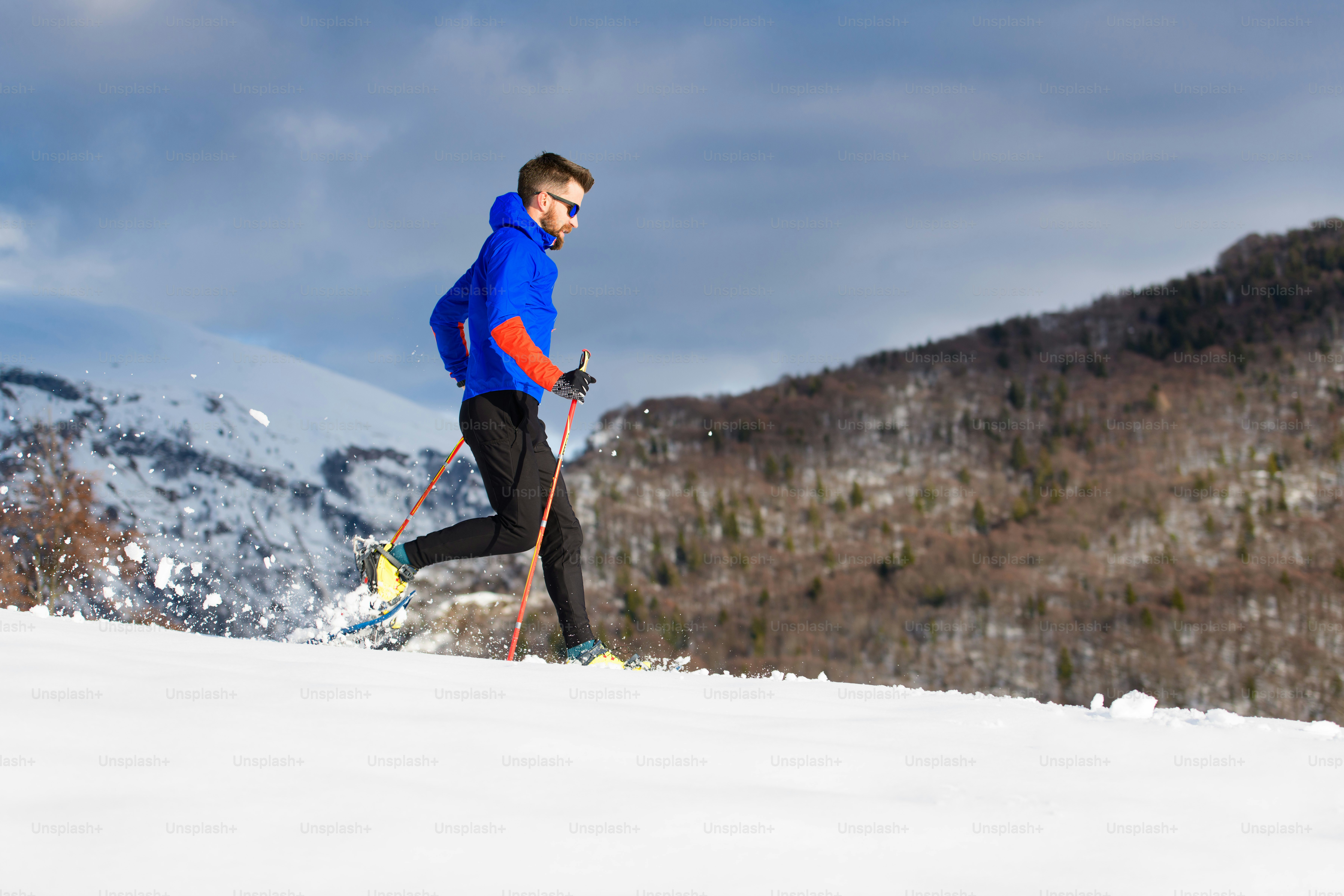 Snowshoeing downhill a boy runs with sticks photo Italy Image on Unsplash