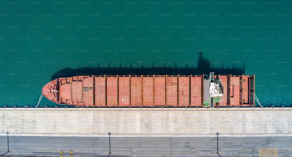 Aerial top view containers ship cargo business commercial trade logistic and transportation of international import export by container frieght cargo ship in the open seaport.