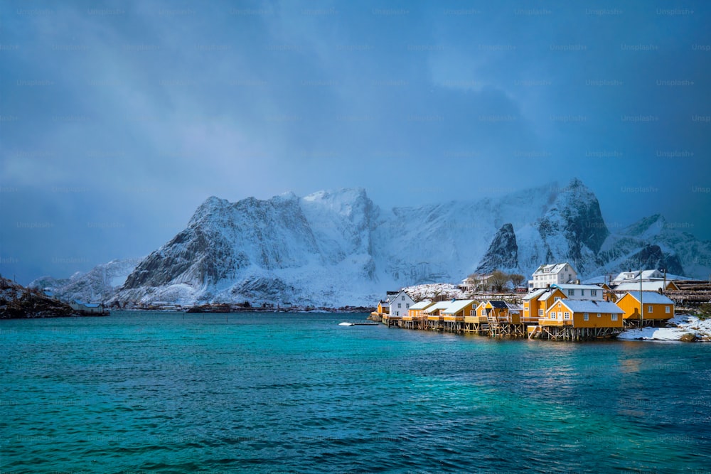 冬に雪が降るサクリソイ漁村の黄色いロルブの家。ロフォーテン諸島、ノルウェー