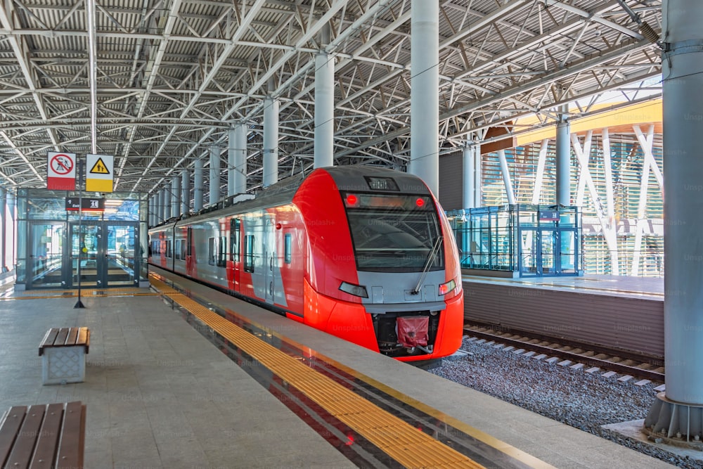 Passenger commuter train on station platform awaiting passengers