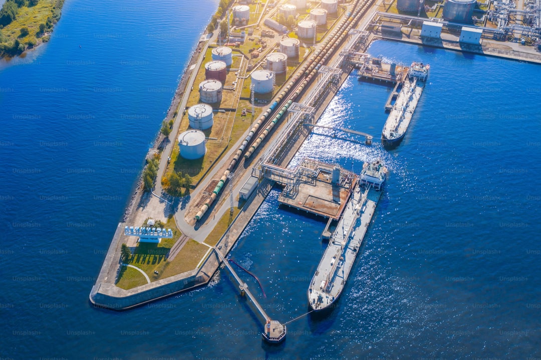 Aerial view large port oil loading terminal with large storage tanks. Railway infrastructure for the delivery of bulk ca