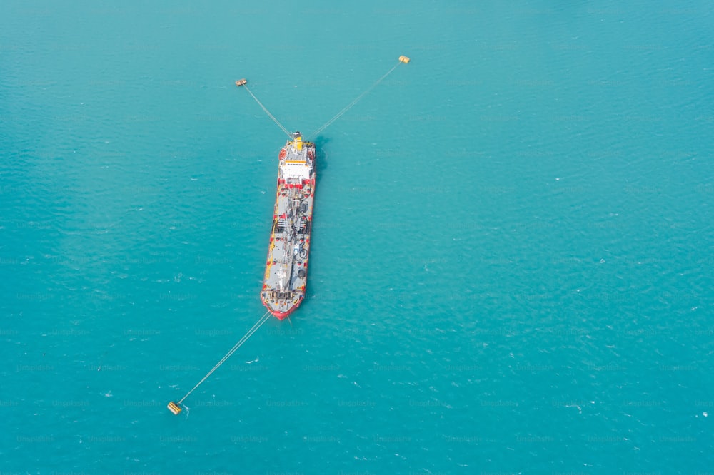 Aerial view of tanker fuel ship moored in a port bay to buoys