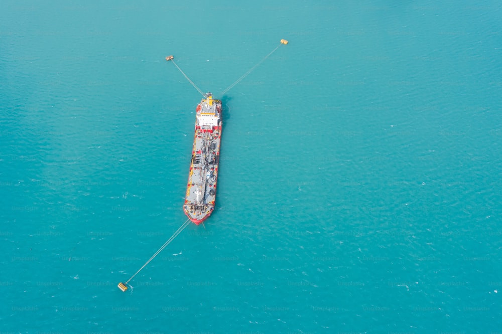 Aerial view of tanker fuel ship moored in a port bay to buoys