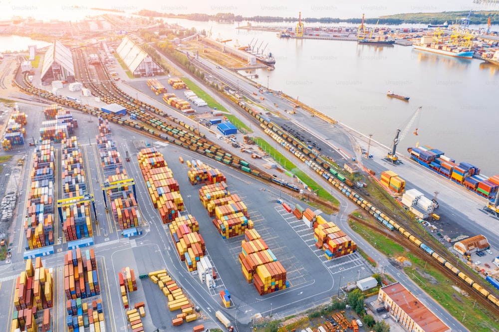 Panoramic aerial top view from the heights of the cityscape port harbor and industrial area, container warehouse and railway system network leading to the seaport