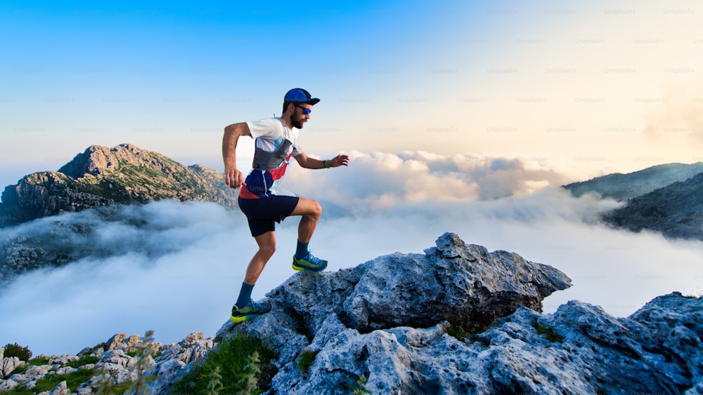 Man ultramarathon runner in the mountains during a workout