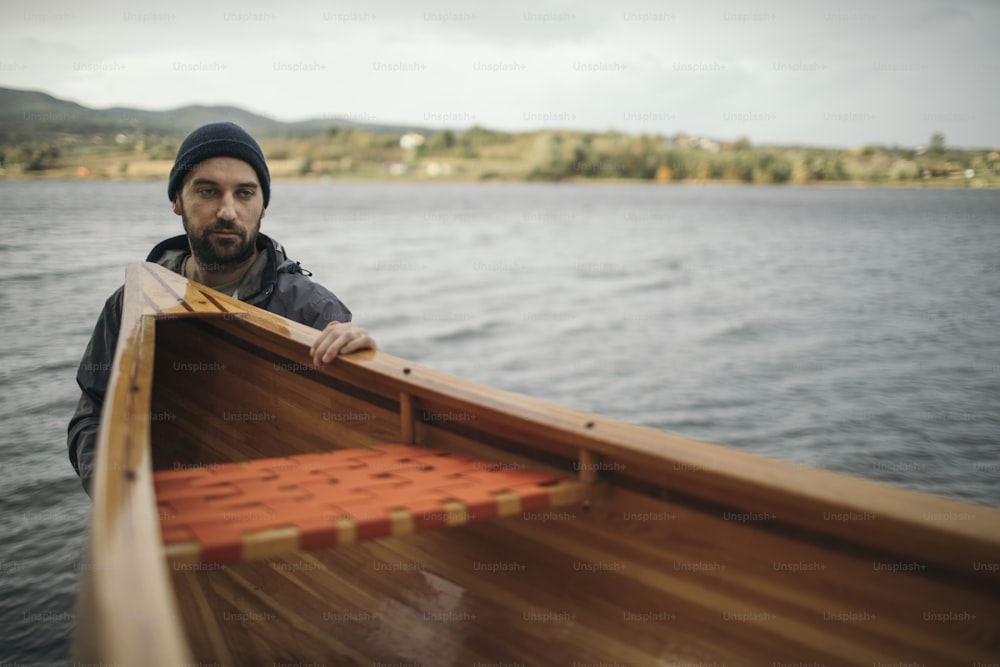 Fisherman holding canoe for a ride.