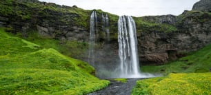 Magical Seljalandsfoss Waterfall in Iceland. It is located near ring road of South Iceland. Majestic and picturesque, it is one of the most photographed breathtaking place of Iceland.