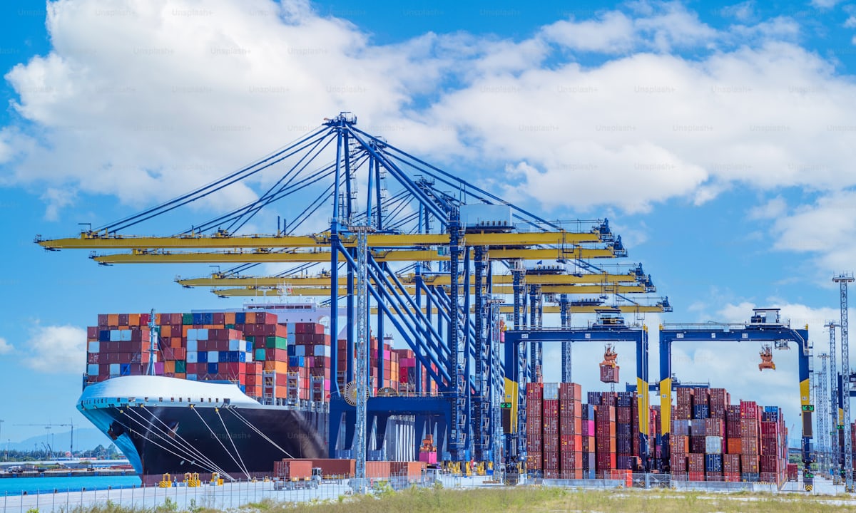 Cargo ship docked at a container terminal with cranes