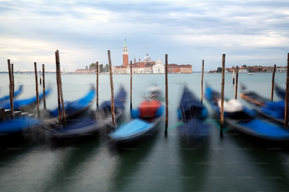 Gondolas in Venice, Italy from St Mark's Square (Piazza san Marco) with gorgeous view of San Giorgio Maggiore Church. Venice is famous travel destination of Italy for its unique cityscape and culture.