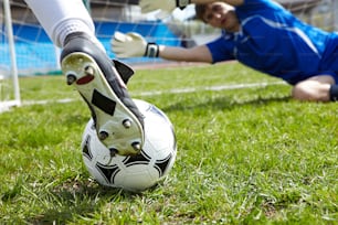 Horizontal image of soccer ball with foot of player kicking it