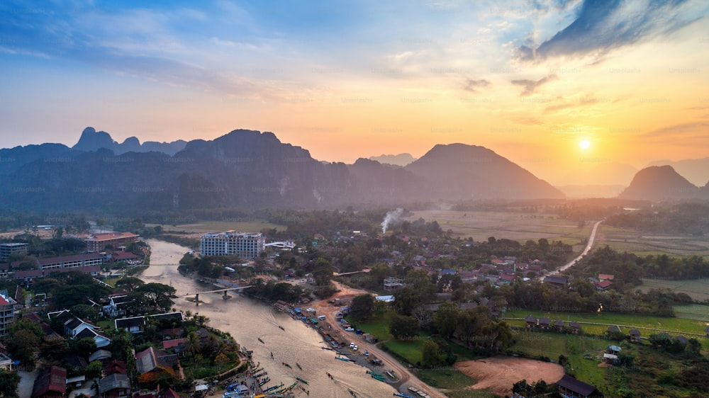 Aerial view of Vang vieng with mountains at sunset.