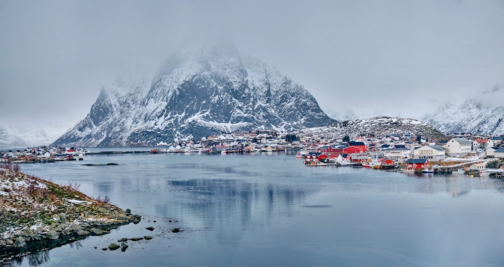 Panorama of Reine fishing village on Lofoten islands with red rorbu houses in winter with snow. Lofoten islands, Norway