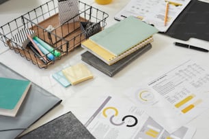 Close-up of financial reports with books and notebooks on the table