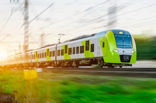 High speed train rides at high speed at the railway station in the city